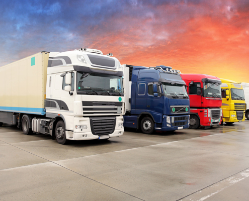 Commercial Trucks with Baldwin Filtration Solutions A lineup of colorful commercial trucks parked side by side, representing heavy-duty vehicles supported by Baldwin filters from A&C Engineering.