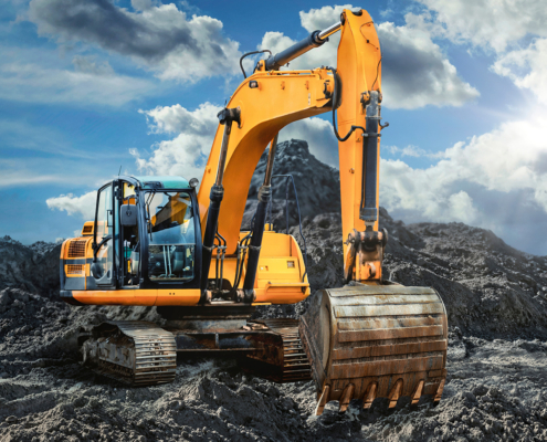 Electromechanical Solutions for Mobile Machinery Excavator at a construction site representing electromechanical drive and motion control solutions for mobile machinery.